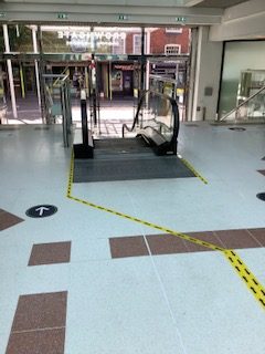 Entrance flooring near an escalator.