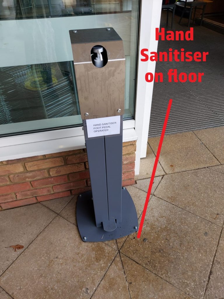 Hand sanitiser station, with residue on the floor